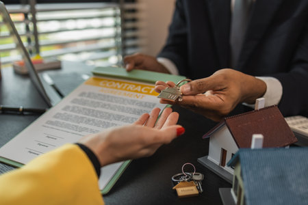 after signing a contract to purchase or lease a property, the salesperson will then hand over the keys so that the buyer or tenant can enter the living spaceの写真素材