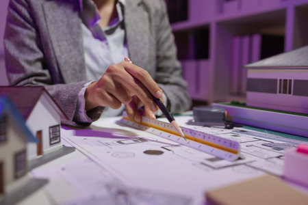 a beautiful female architect is working in her private office because she needs to concentrate on...