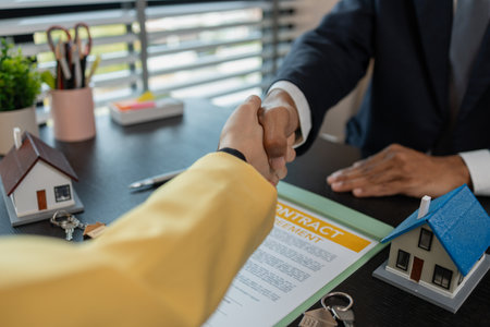 they shake hands after the home purchase contract is approved, agents shake hands with buyers after the property purchase is completed, contract, property, investmentの写真素材