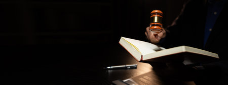a lawyer was working overtime in the lawyers council office until late at night, the lawyer remained in the office because there were many client documents that needed to be checkedの写真素材