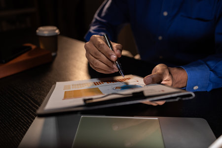 a businessman works overtime is his accounting firm's office until late at night, an entrepreneur...