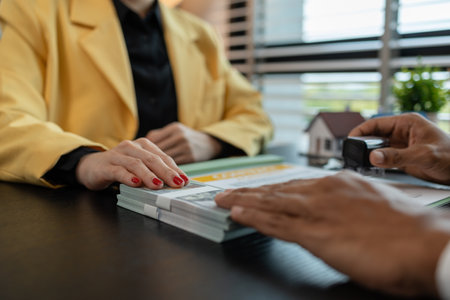 the buyer or renter is placing a deposit money with the real estate agent after signing a contract to rent or purchase a residence, property, estate, investment, mortgageの写真素材