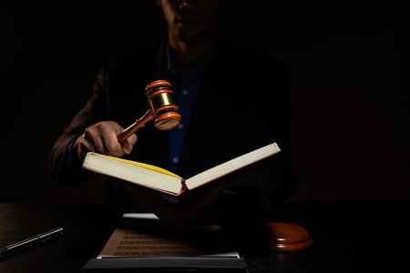 a lawyer was working overtime in the lawyers council office until late at night, the lawyer remained in the office because there were many client documents that needed to be checkedの写真素材