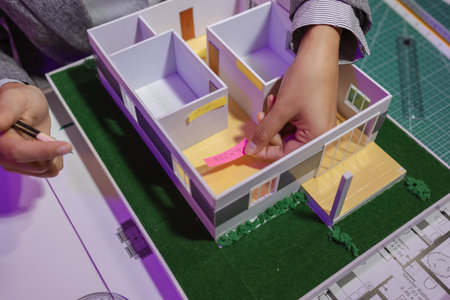 a passionate female architect works in her private office to remodel a house to meet her client's...