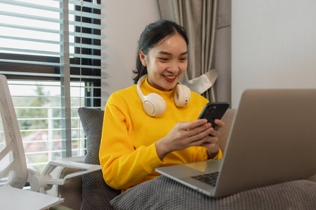 a businesswoman is working at home on the weekend, an employee had to take work home because there were so many documents she had to edit that she couldn't finish them in her working hoursの写真素材