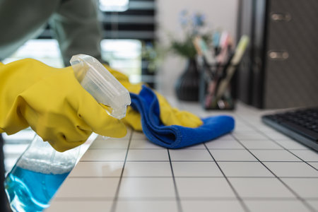 a company's cleaning lady is diligently cleaning the executive's office, the cleaning lady wears...