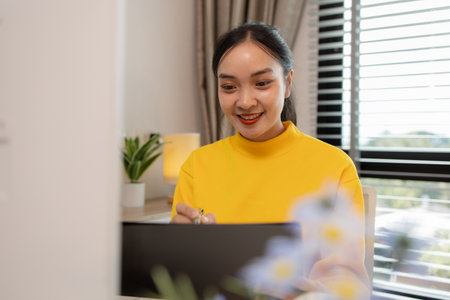 a businesswoman is working at home on the weekend, an employee had to take work home because there were so many documents she had to edit that she couldn't finish them in her working hoursの写真素材