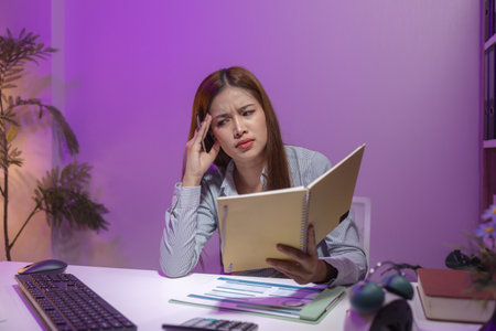 this businesswoman was sitting in her private office working and lost track of time because of the amount of work she had to do, overtime, overwork, tired, overworked, troubleの写真素材