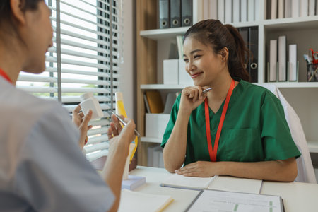 two doctors are meeting to exchange new knowledge and information they have gained form their medical seminars with each other, a senior doctor is explaining information and knowledgeの写真素材