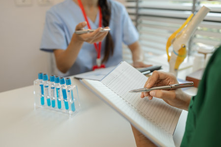 consultation between two doctors in the office, two medical students are discussing treatment guidelines for a patient assigned to them by a senior physician, nurse, brainstorming, hospitalの写真素材