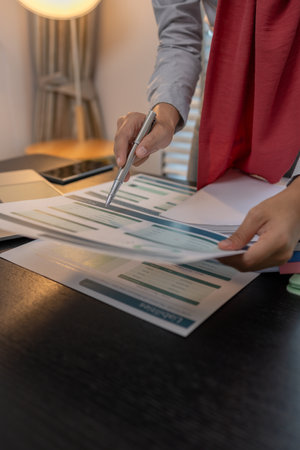 a muslim female entrepreneur is reviewing her company's financial documents, marketing, accountant, hijab, islam, a muslim company employee works in a large financial organizationの写真素材