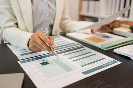 working in the office with a lot of paperwork, businessman is checking marketing data, an employee is working with finance document, sitting in the office working for an accountant companyの写真素材