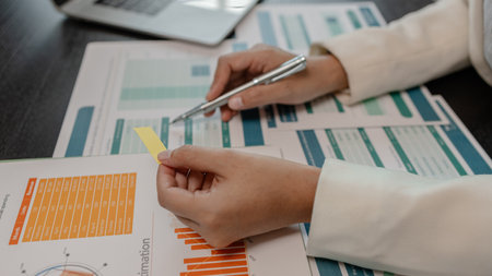 businessman is checking financial documents to match the information summarized by the accounting department, accountant, marketing department, working in the office with paperworkの写真素材