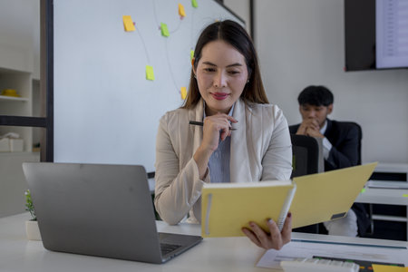 the atmosphere of the company's employees working together, the finance department staff work with the accounting department, a group of businessmen are exchanging insights with each otherの写真素材