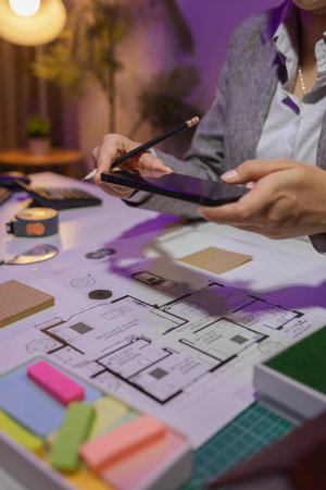 a beautiful female architect is working in her private office because she needs to concentrate on improving the blueprints to be in accordance with the law, engineer, foreman, contractorの写真素材