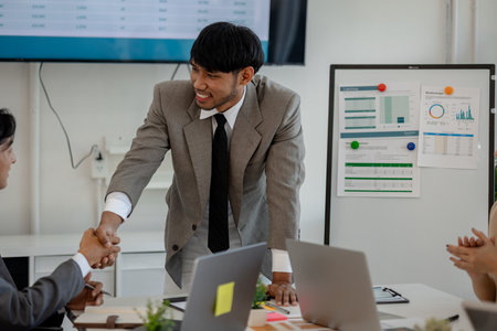 handshake, the atmosphere of working together between the marketing and accounting departments, shaking hand because they find solutions to the company's problems, finance, financial, businessmanの写真素材