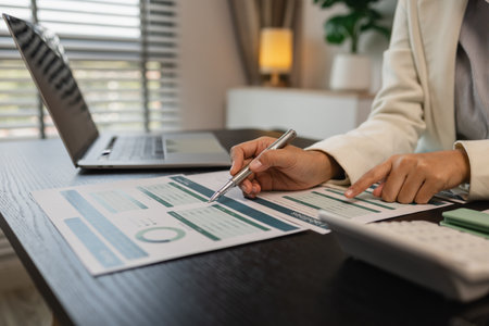 working in the office with a lot of paper work, businessman is checking marketing data, an employee is working with finance document, sitting in the office working for an accountant companyの写真素材