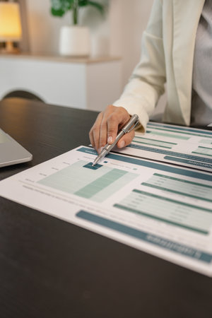 working in the office with a lot of paper work, businessman is checking marketing data, e an employee is working with finance document, sitting in the office working for accountant companyの写真素材