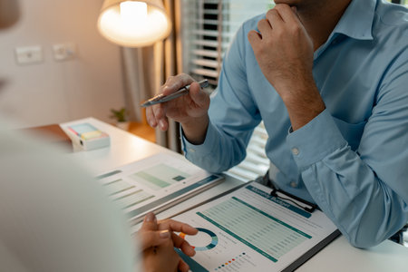 the company's auditing staff is checking the documents for accuracy in the office, businessman is explaining information in a document to his partner, graph, entrepreneur, marketingの写真素材