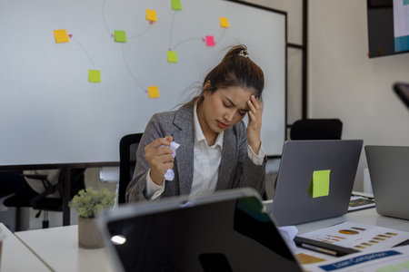 businessman is stressed because of overworked, a company employee is very tired because of the deadline, showing signs of fatigue and stress in the office, serious, entrepreneurの写真素材