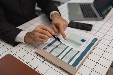 a businessman is studying information in a document to gain a better understanding, a department...