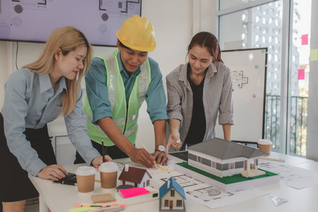 the architect and his team are meeting with the construction supervisor to brainstorm on how to...