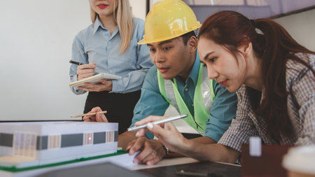 the architect and his team are meeting with the construction supervisor to brainstorm on how to...