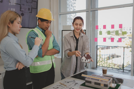 the architect and his team are meeting with the construction supervisor to brainstorm on how to...