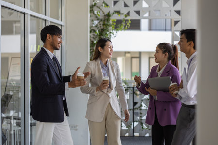 business people are talking while walking in the company, all the planning department staff are walking to a meeting together, business owners are talking while walking to the officeの写真素材