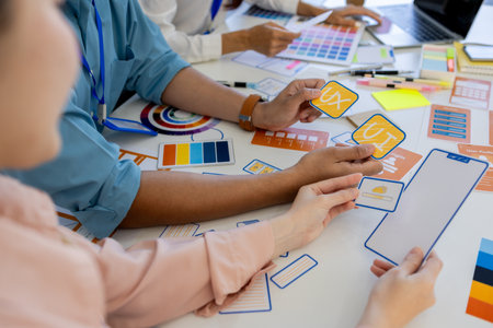 ux, ui, web and mobile app designers are discussing the look and feel of the website or app they are...