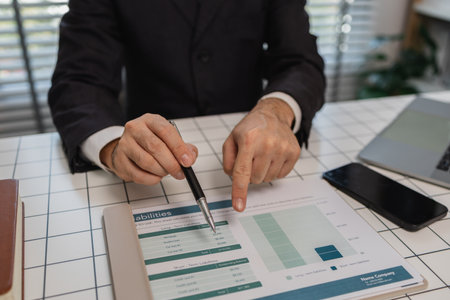 a businessman is studying information in a document to gain a better understanding, a department...