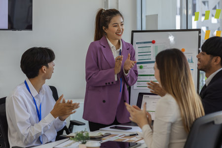 businesspeople show their joy by clapping or expressing their facial expressions by shouting 'yes' because the project is successful, employees are happy that the meeting went well, cheerful, joyfulの写真素材