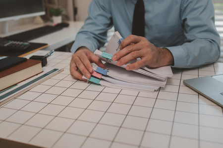 a businessman is handling documents in the office, an accountant is collecting documents, a...