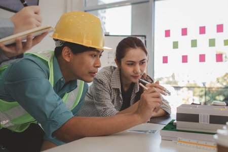 the architect and his team are meeting with the construction supervisor to brainstorm on how to...