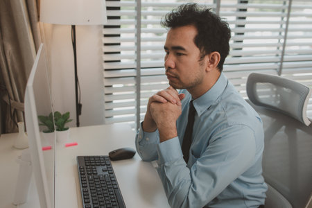 a businessman is sitting in his private office, an entrepreneur is working diligently, the chief accountant is reviewing documents and budget figures to present to the executives in a meetingの写真素材