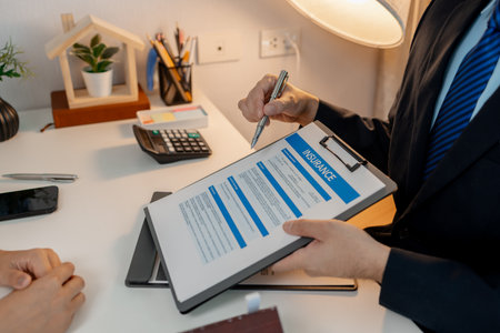 the staff is explaining information about home insurance documents to the buyers, when buying a house you must also buy home insurance for the safety of the property, investmentの写真素材