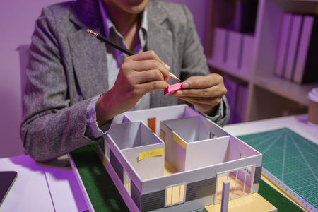 a passionate female architect works in her private office to remodel a house to meet her client's...