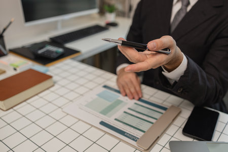 a financial expert is consulting with a client who wants to plan his finances after retirement, a businessman is talking with his partner about the next project they will do together, paperworkの写真素材