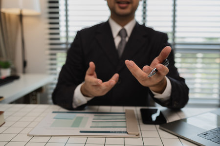 a financial expert is consulting with a client who wants to plan his finances after retirement, a businessman is talking with his partner about the next project they will do together, paperworkの写真素材