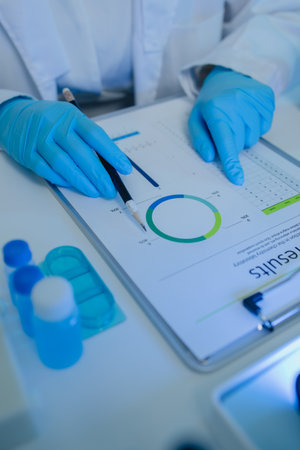 a female chemist is testing various liquid compounds in a lab, a scientist is doing research on the development of science in a lab, laboratory, test tube, scientificの写真素材