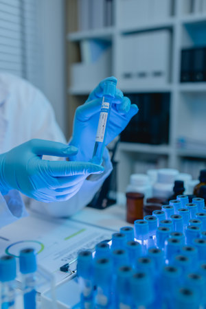 a female chemist is testing various liquid compounds in a lab, a scientist is doing research on the...