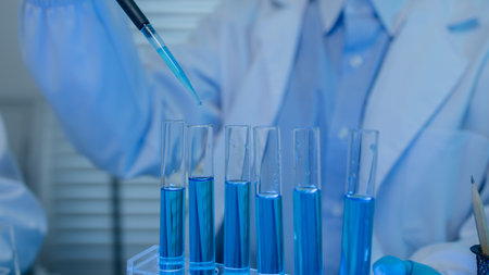 a female chemist is testing various liquid compounds in a lab, a scientist is doing research on the development of science in a lab, laboratory, test tube, scientificの写真素材