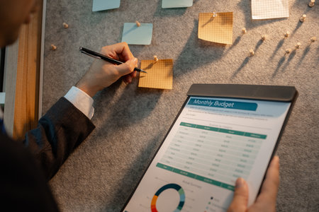 chart-based statistical data is prepared by accounting staff to present the company's income and expenditure data, a businessman prepares marketing and financial information for presentationの写真素材