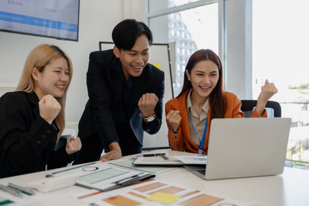 the group of business people showed their joy by clapping and giving high fives because of their success in business, joyful, cheerful, brainstorming in the meeting room, businessmanの写真素材