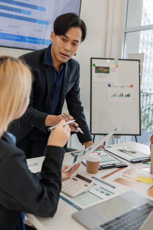 one of marketing team is explaining the presentation to the team, group of businessman are meeting in the office, these entrepreneur are brainstorming about their business project, finance, accountingの写真素材