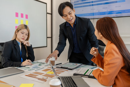 one of marketing team is explaining the presentation to the team, group of businessman are meeting in the office, these entrepreneur are brainstorming about their business project, finance, accountingの写真素材