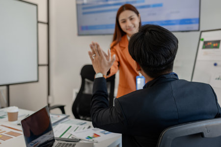 the group of business people showed their joy by clapping and giving high fives because of their success in business, joyful, cheerful, brainstorming in the meeting room, businessmanの写真素材