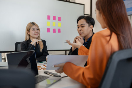 one of marketing team is explaining the presentation to the team, group of businessman are meeting in the office, these entrepreneur are brainstorming about their business project, finance, accountingの写真素材