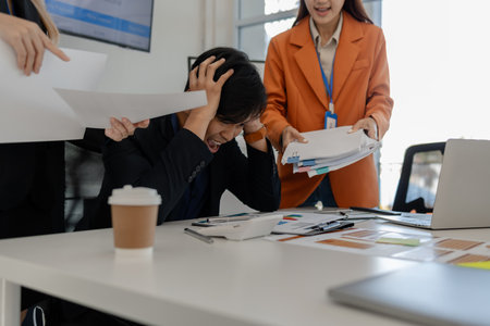 these businessmen are under stress because their company is facing problems, the company is facing a financial crisis which is causing their business to go bankrupt, stressed, startupの写真素材