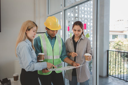 architects and engineers are discussing the design and structure of the upcoming building with the...